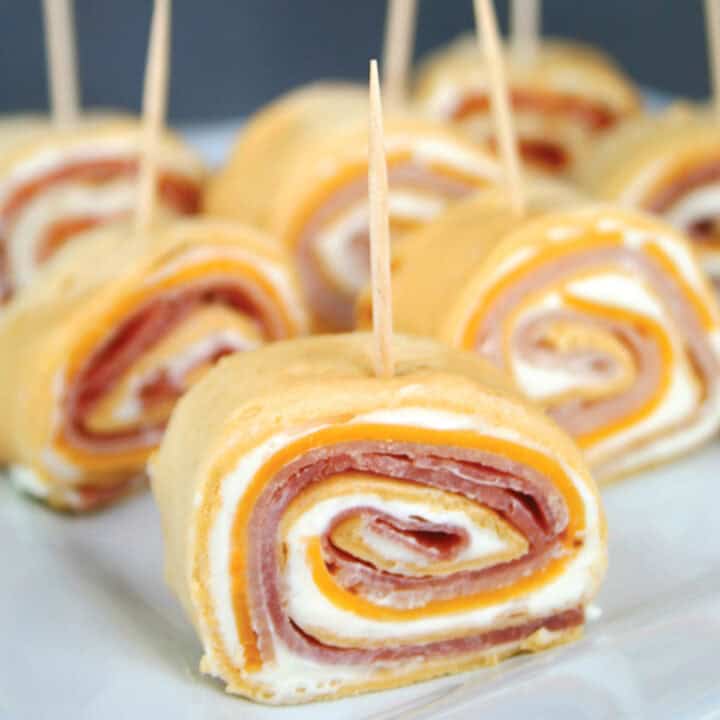 Flour tortillas rollups with ham and cheese and cream cheese.