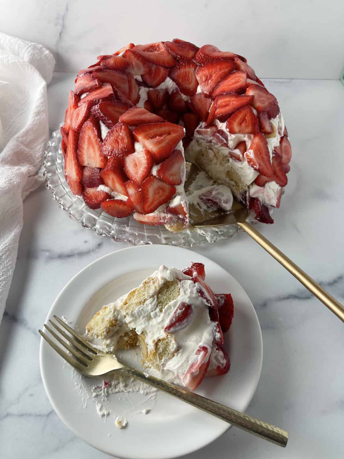 A piece of tiramisu with strawberries on a plate with fork.