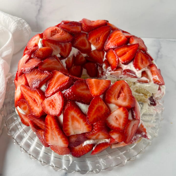 Tiramisu with Strawberries on a crystal cake platter.