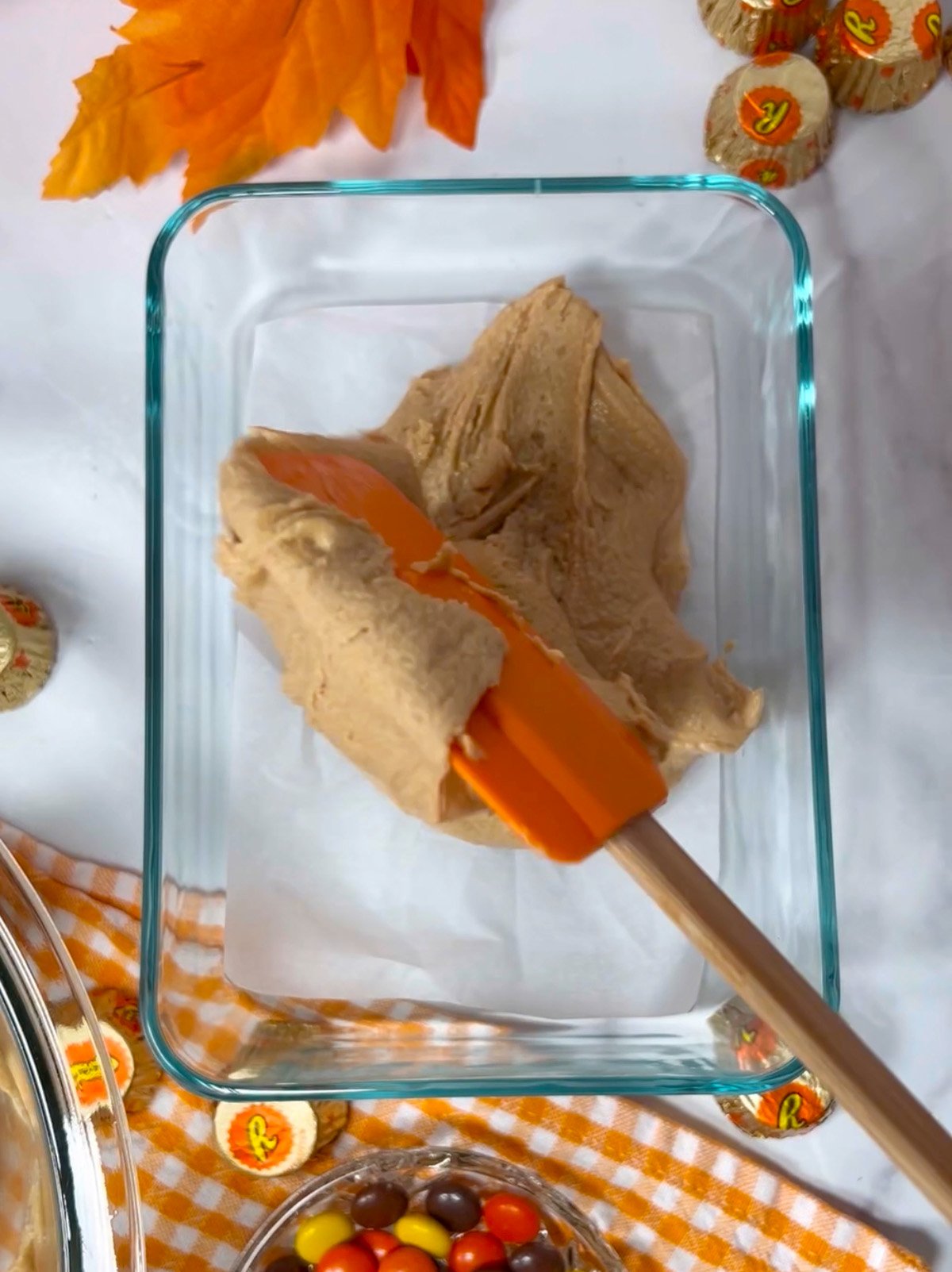 Spreading fudge into prepared pan.