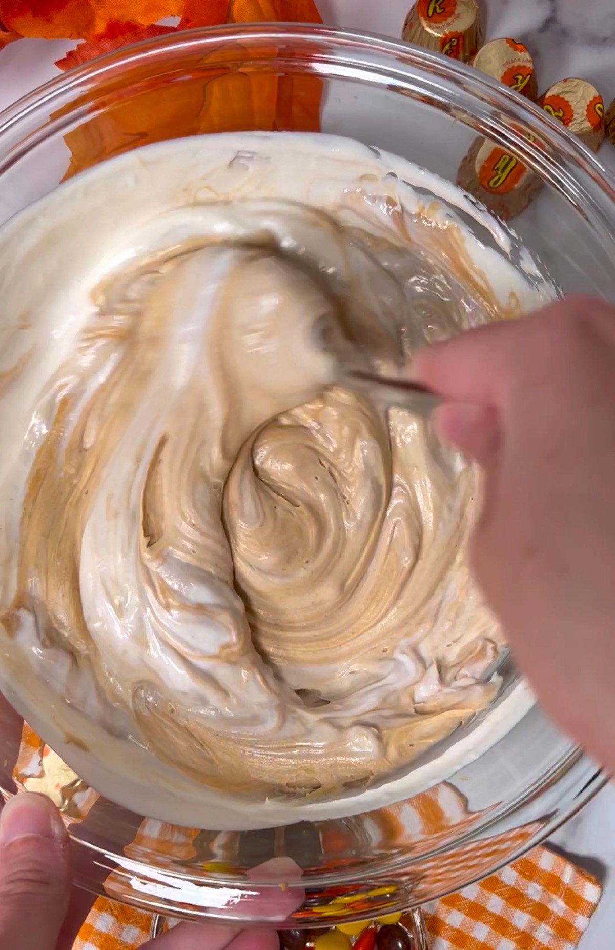 Mixing peanut butter fudge in large bowl.