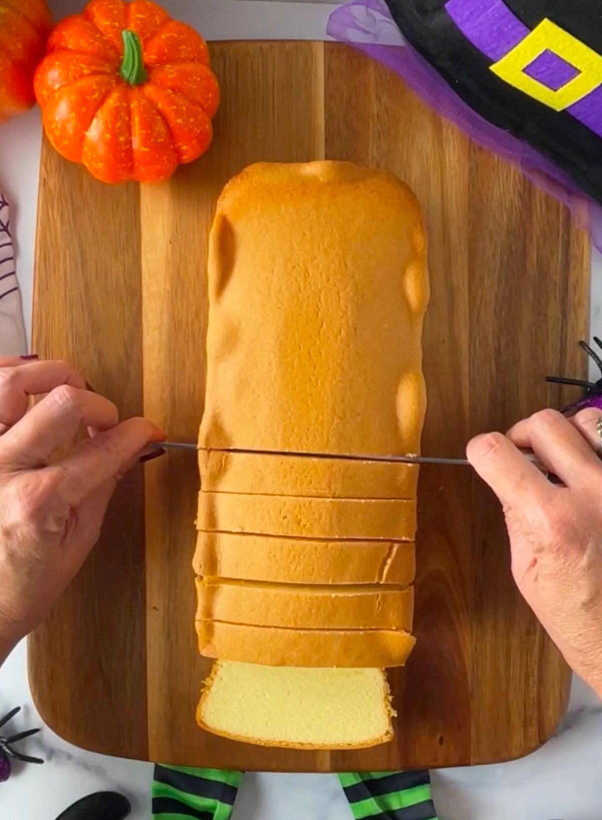 Slicing loaf of pound cake.