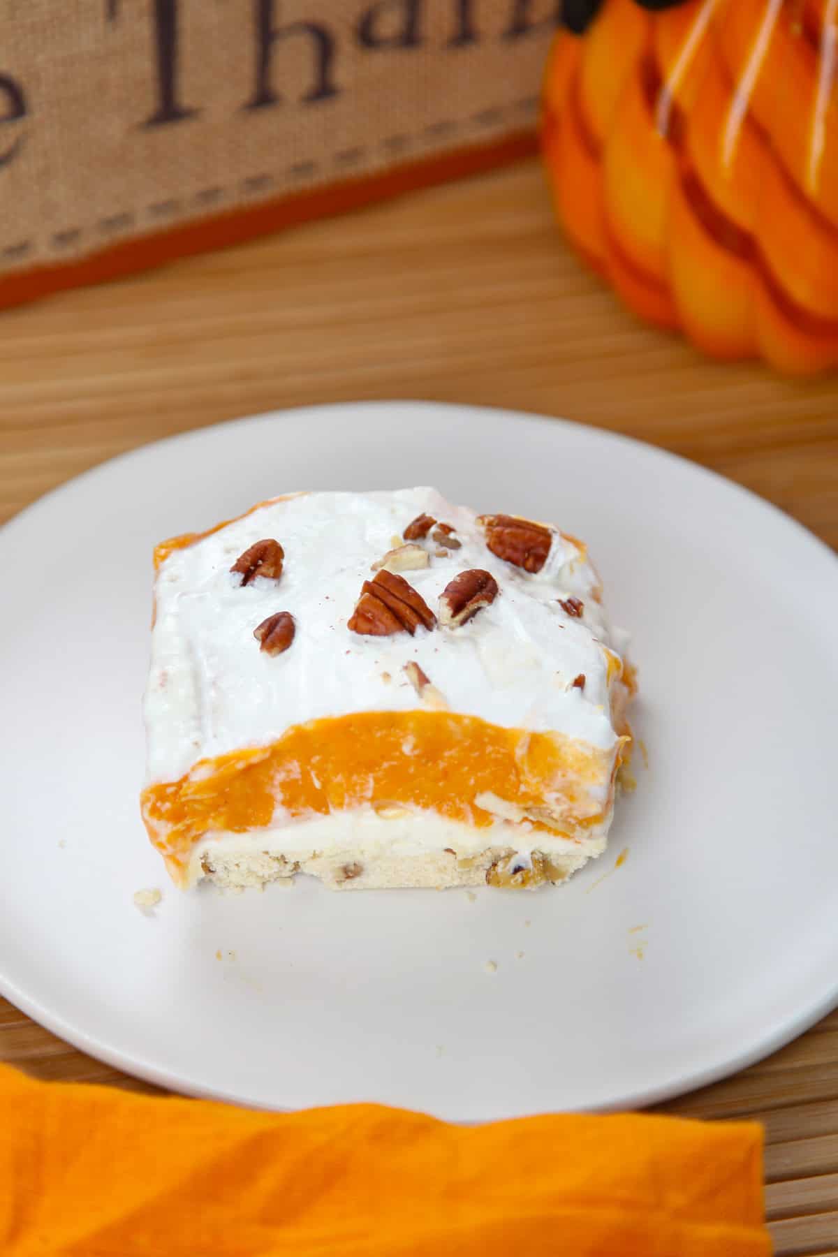 One serving of pumpkin lasagna dessert on a white plate.