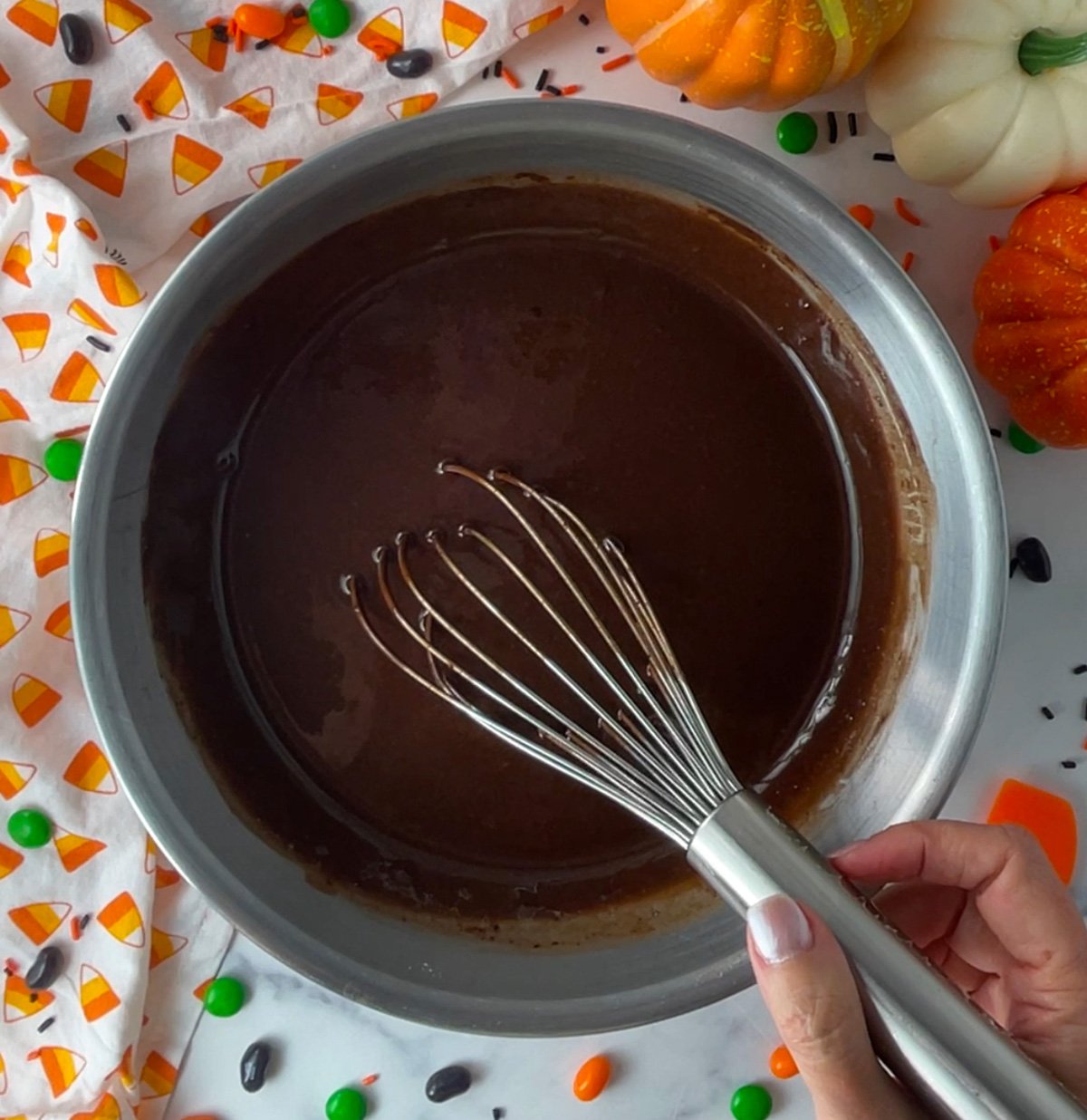 Mixing chocolate cupcake batter in a bowl.