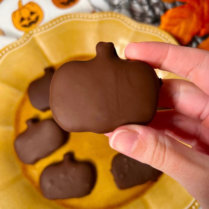 Homemade reese's pb cups shaped like pumpkins with healthier ingredients.