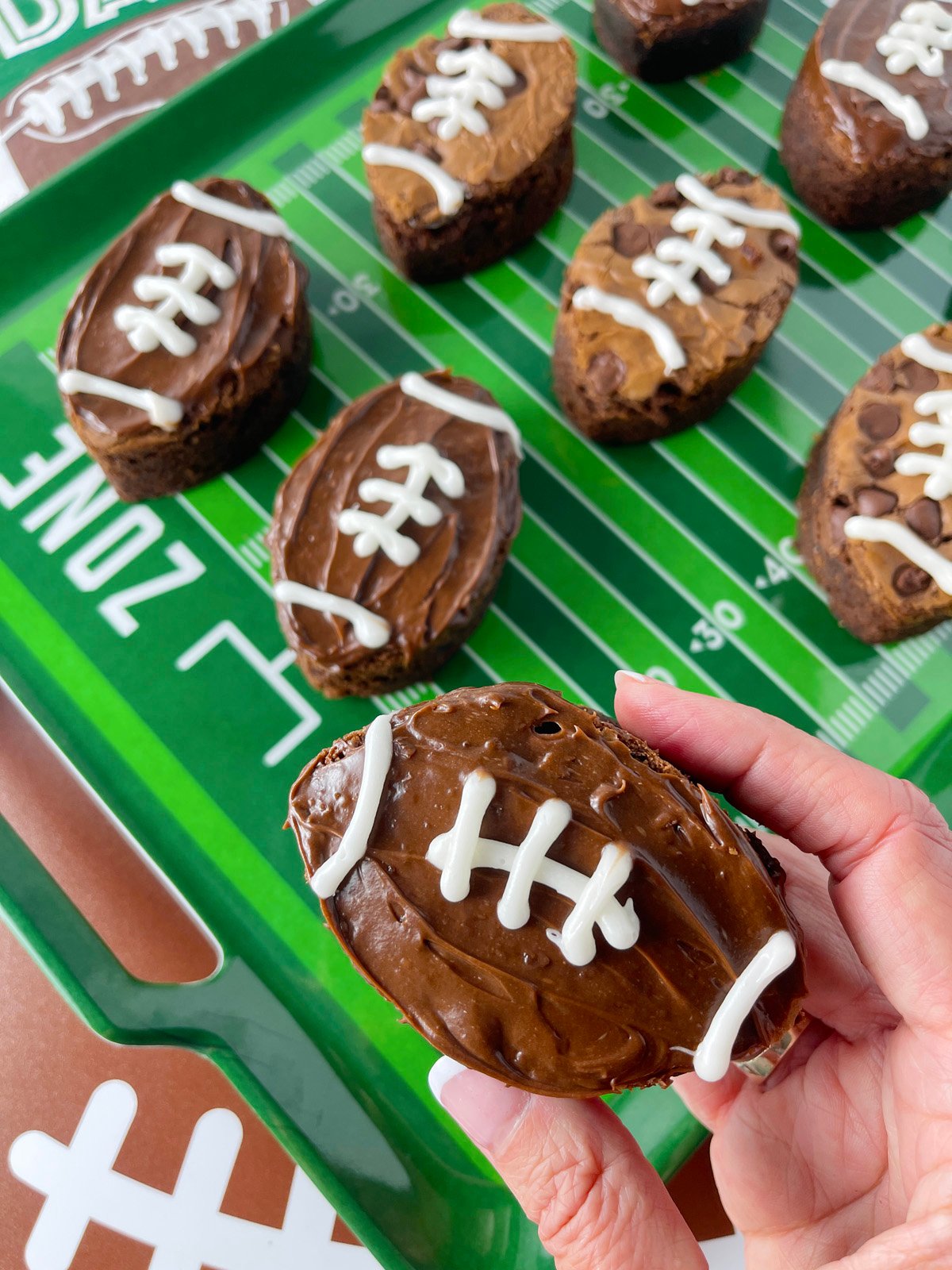 Cute football shaped brownies on a green football field tray from Aldi.