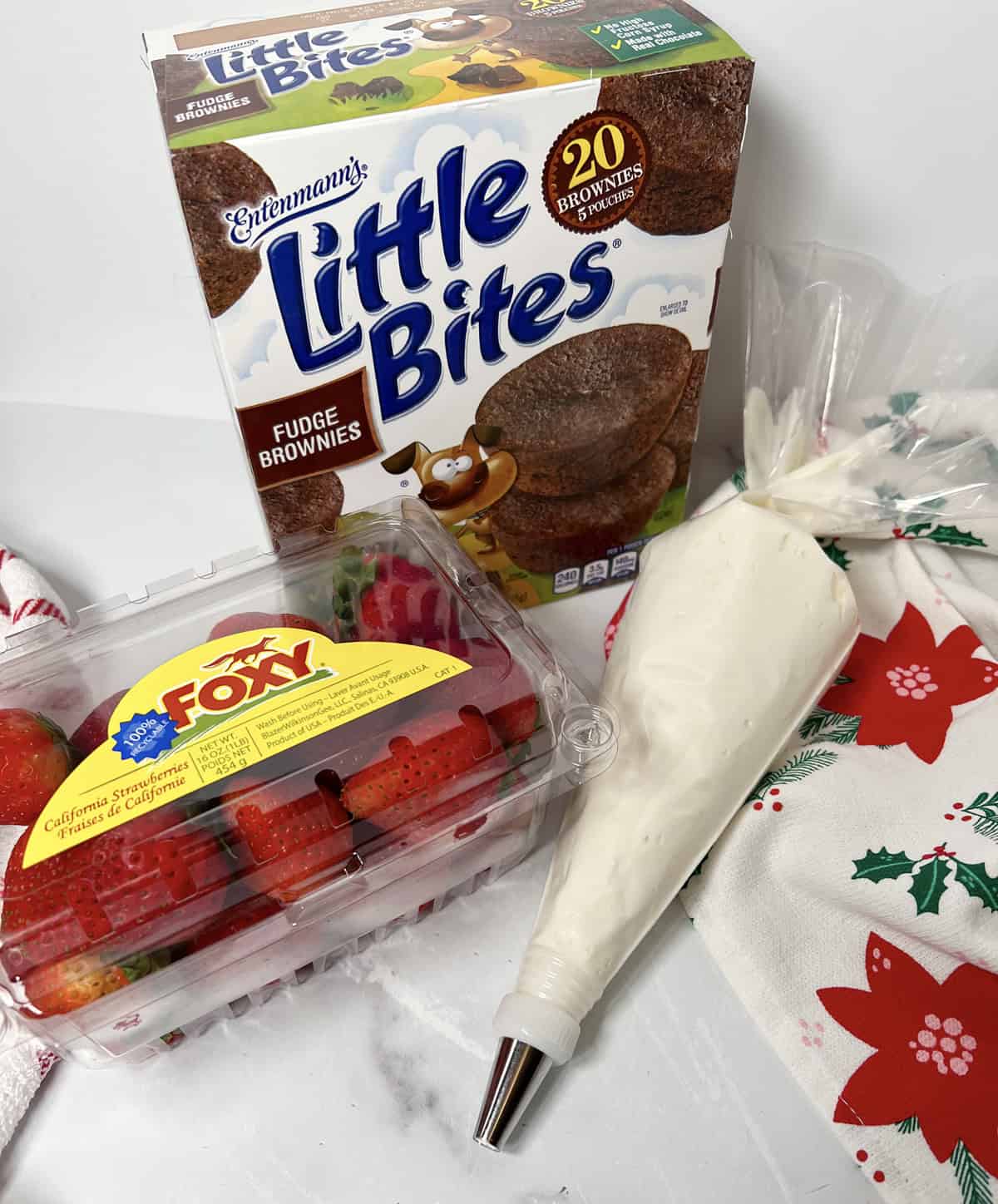 Ingredients needed to make Santa hat strawberry brownie bites.