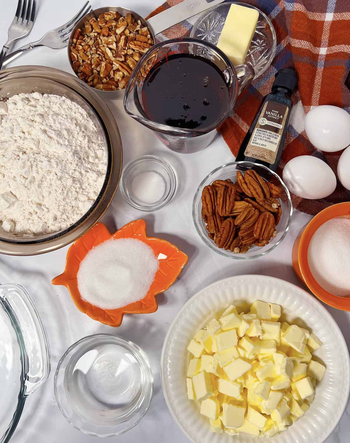 Ingredients needed to make homemade pecan pie.