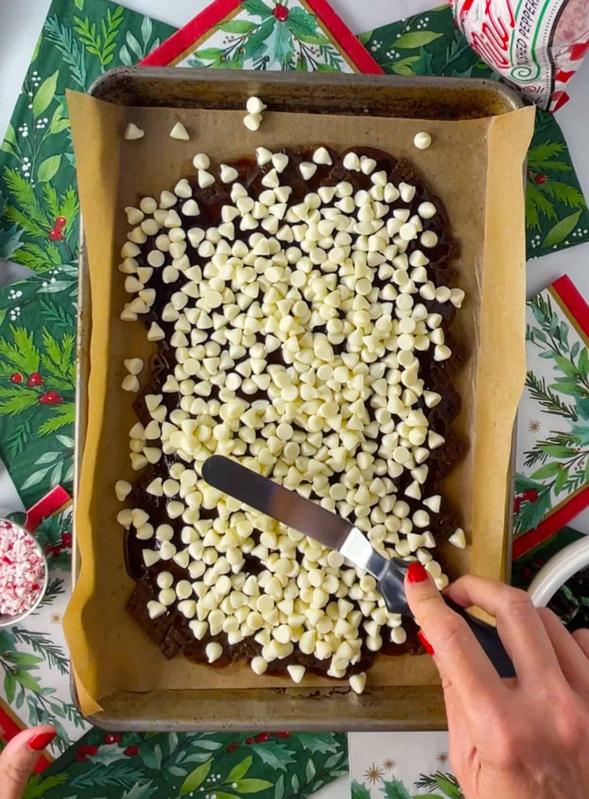 Melted chocolate chips on top of cracker toffee.