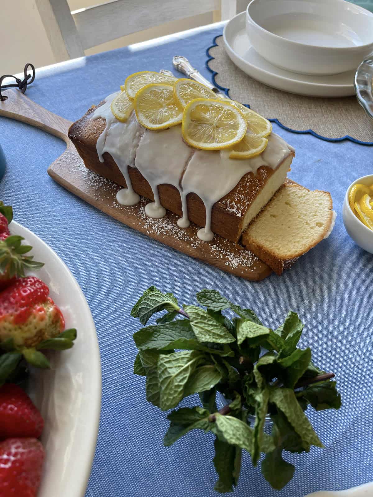 Sliced lemon bread on a cutting board.